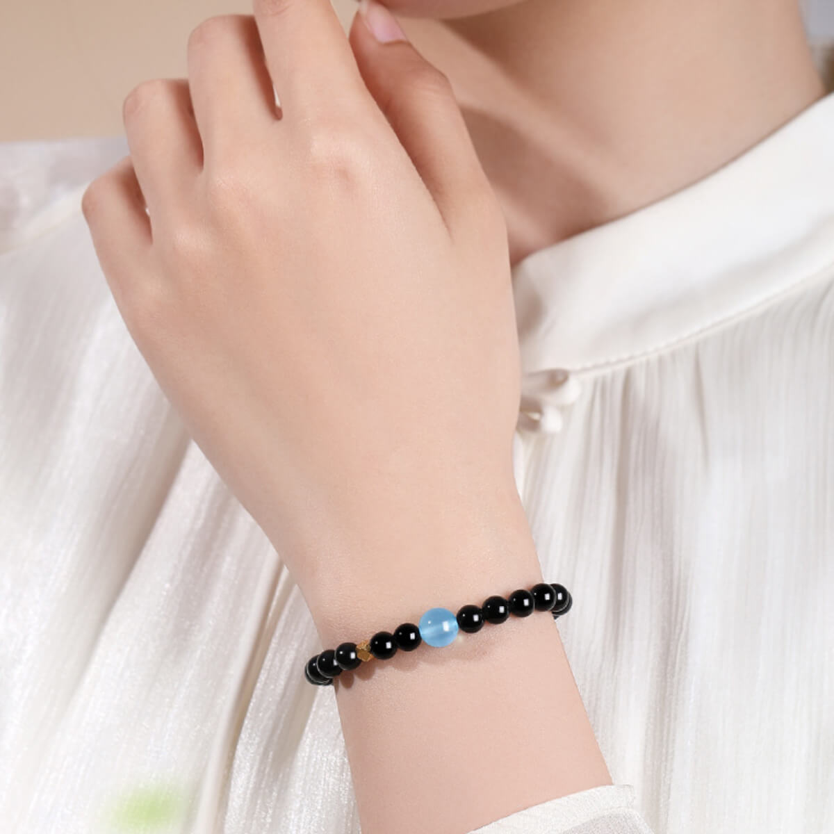 Wrist shot of the Void Series Obsidian and Blueberry bracelet, demonstrating its grounding and protective energy.