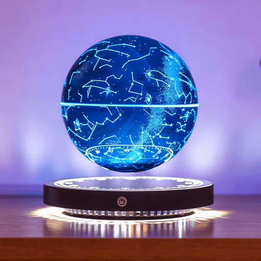 The Galactic Orb night light floating above its base, emitting a soft blue glow in a dark, atmospheric room setting.