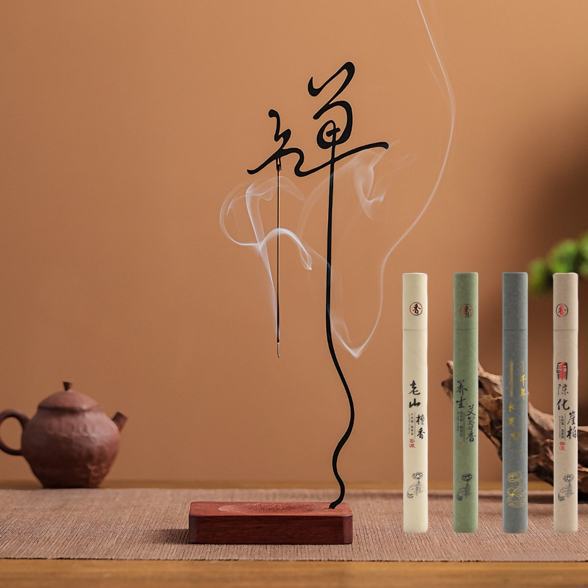 The Inverted Zen Incense Holder made of solid wood and cast iron, presented in a serene desktop setting with the complete set of four complimentary incenses: Sandalwood, Mugwort, Agarwood, and Cypress.