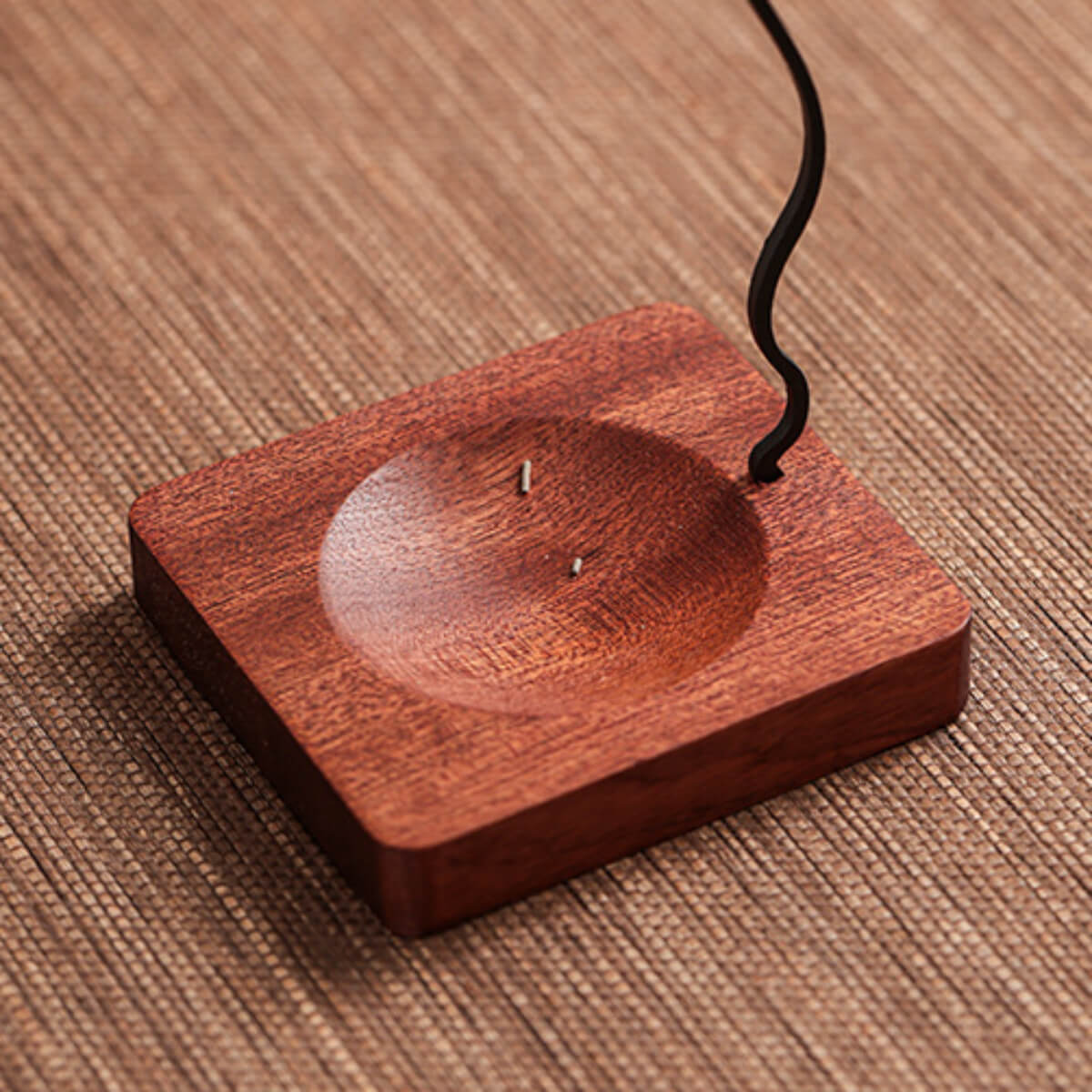 Functional design detail of the Zen Incense Holder, showcasing the dedicated groove in the solid wood base that neatly collects fallen incense ash for easy cleanup.