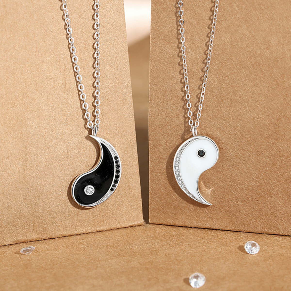 Macro detail of the Yin Yang pendants, showcasing the precise zirconia inlay in S925 silver, symbolizing the presence of one within the other.