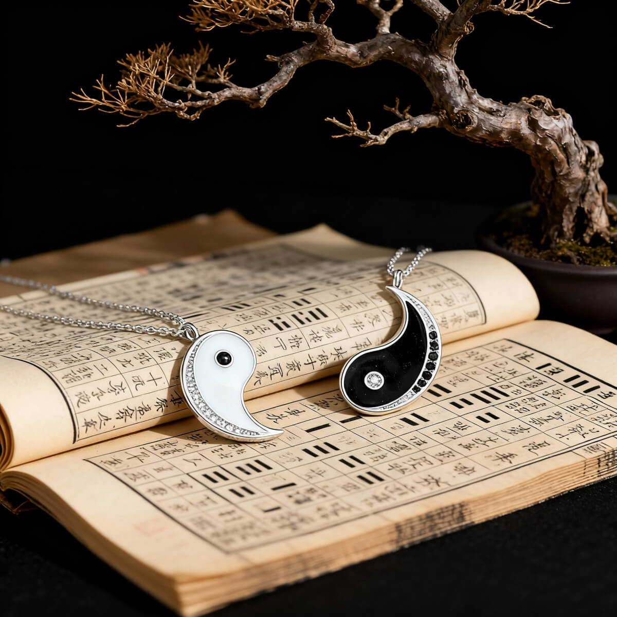 S925 Silver Yin and Yang pendants resting upon the I Ching, an ancient classic that synthesizes natural and cosmic laws into a profound system of text and symbols.